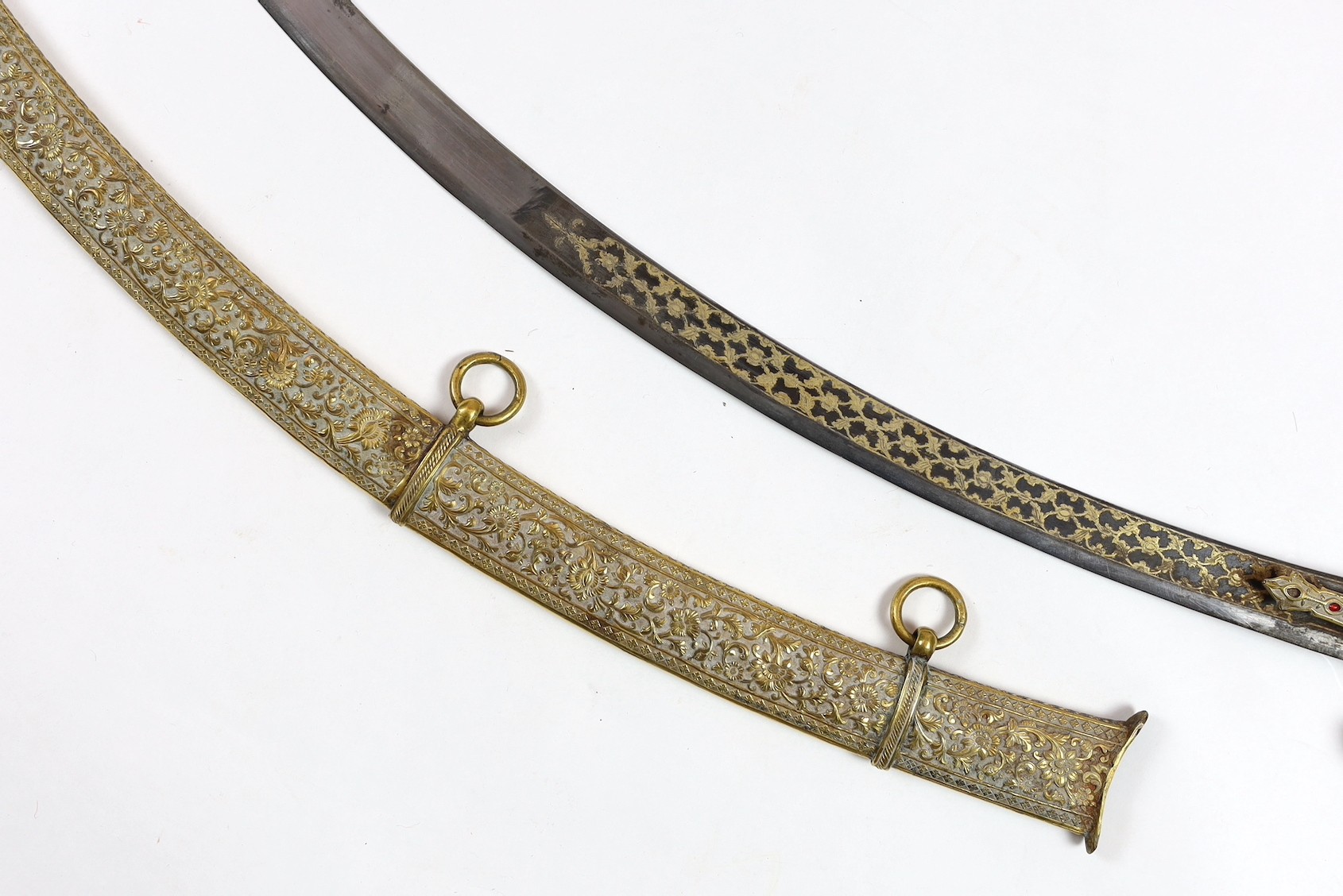 A fine Indian gilt copper and paste mounted sword (shamshir), Kutch, 19th century, sword 79cm long, scabbard 75cm long